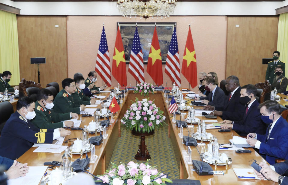 U.S Defense Secretary Lloyd Austin, third from right, and Vietnamese Defense Minister Phan Van Giang, third from left, hold a meeting in Hanoi, Vietnam, Thursday, July 29, 2021. Austin is seeking to bolster ties with Vietnam, one of the Southeast Asian nations embroiled in a territorial rift with China, during a two-day visit. (Nguyen Trong Duc/VNA via AP)