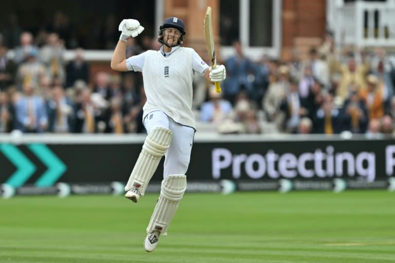 History maker: Joe Root celebrates after completing an England record 34th Test century, in the second Test against Sri Lanka at Lord's (Glyn KIRK)