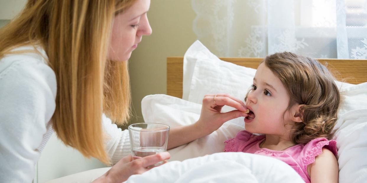 mother giving her daughter medicine Singulair concerns