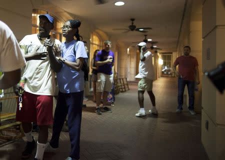 People concerned about relatives seek information from police nearby the scene of a shooting at the Emanuel AME Church in Charleston, South Carolina, June 17, 2015. REUTERS/Randall Hill