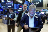 A trio of traders work on the floor of the New York Stock Exchange, Friday, Aug. 25, 2023. (AP Photo/Richard Drew)