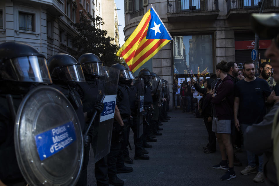 Catalan police officers cordon off the street to stop pro independence demonstrators, on their way to meet demonstrations by members and supporters of National Police and Guardia Civil in Barcelona on Saturday, Sept. 29, 2018. (AP Photo/Emilio Morenatti)