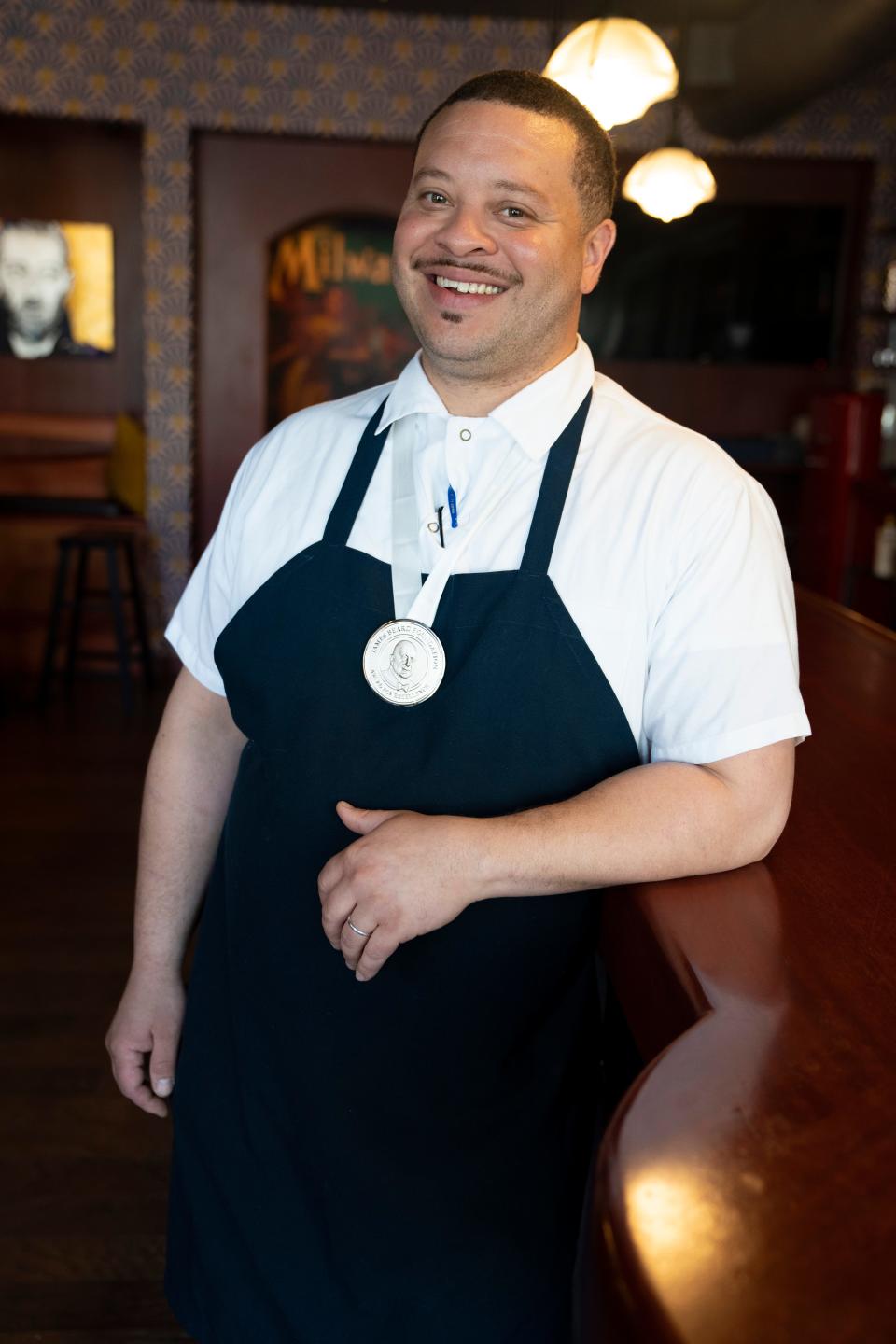 Dane Baldwin, chef/owner of The Diplomat at 815 E. Brady St. in Milwaukee, shows his medal for winning the 2022 James Beard best chef Midwest honor. Baldwin is shown back at his restaurant on June 15.