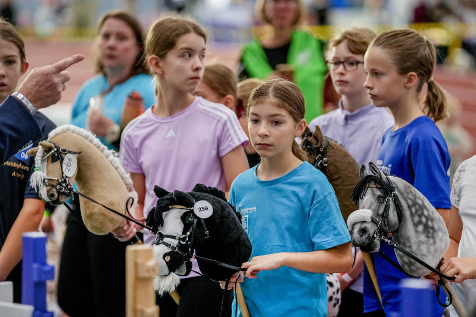 Competitors are instructed during the first German Hobby Horsing Championship in Frankfurt, Germany, Saturday, Sept. 14, 2024. (AP Photo/Michael Probst)