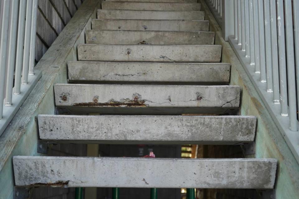 A staircase is degrading at the Meadow Wood Townhomes on Sept. 22, in Bellingham, Washington. Multiple steps show exposed rebar where the cement has been chipped away. Rachel Showalter/The Bellingham Herald