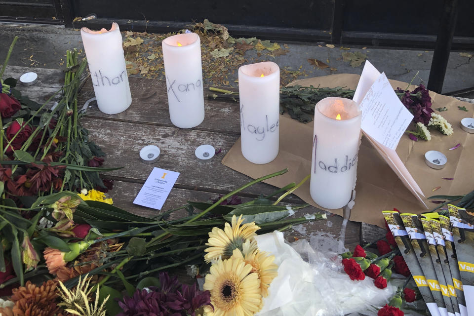 Candles and flowers are left at a makeshift memorial honoring four killed University of Idaho students, Nov. 15, 2022.