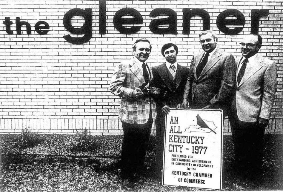 Henderson won a place in the Kentucky Chamber of Commerce Hall of Fame for 1977 and local officials lined up with the plaque in front of The Gleaner building. Pictured, from left, are Gleaner publisher Walt Dear, who headed the application process, chamber president Jim Hayes, Mayor Bill Newman, and County Judge A.G. Pritchett.