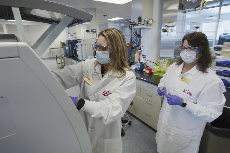 FILE - In this May 2020 photo provided by Eli Lilly, researchers prepare cells to produce possible COVID-19 antibodies for testing in a laboratory in Indianapolis. The drug company says it has asked the U.S. government to allow emergency use of an experimental antibody therapy based on early results from a study suggesting the drug reduced symptoms, the amount of virus and hospitalizations and ER visits for patients with mild or moderate COVID-19. Eli Lilly and Company announced the partial results Wednesday, Oct. 7 in a news release; they have not yet been published or reviewed by independent scientists. Its drug is similar to one that President Donald Trump received on Friday, Oct. 2 from Regeneron Pharmaceuticals Inc. (David Morrison/Eli Lilly via AP, File)