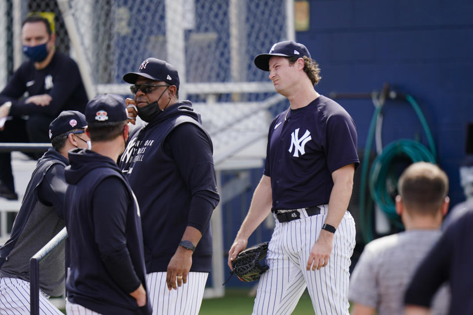 New York Yankees' Gerrit Cole, right, reacts after a spring training baseball workout Monday, Feb. 22, 2021, in Tampa, Fla. (AP Photo/Frank Franklin II)