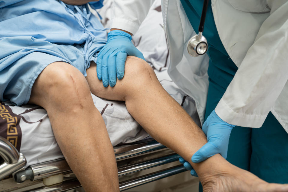 A doctor holding a patient's leg