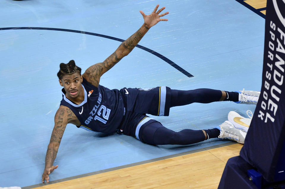 Memphis Grizzlies guard Ja Morant (12) looks to a referee after scoring in the second half of an NBA basketball game against the Milwaukee Bucks, Thursday, March 4, 2021, in Memphis, Tenn. (AP Photo/Brandon Dill)