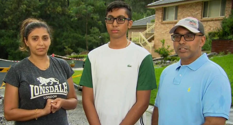 Mr and Mrs Buksh with their son in front of their home.