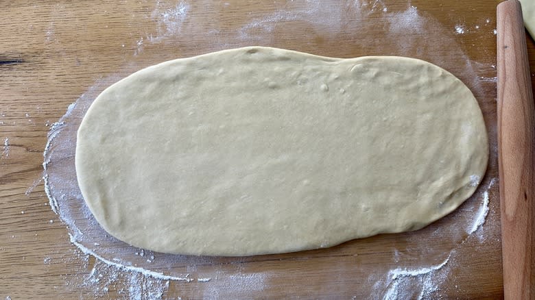 rolled dough on floured surface