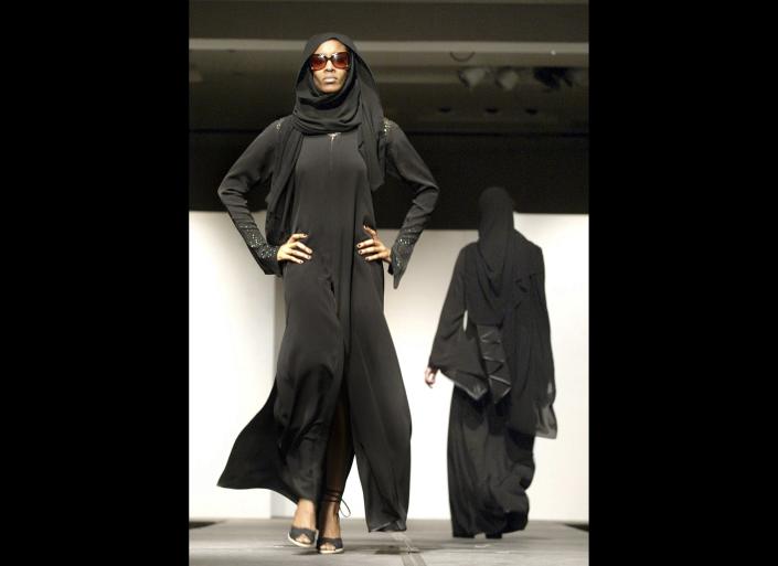 An abaya is a long black, loose fitting cloak that often zips or buttons up the front.  The sheila is a rectangular scarf that covers the head.  Usually made of light silk material and most often found in black, but can be as simple or elaborate as the wearer so chooses. Generally these garments are part of a region's traditional dress, and are therefore worn for cultural reasons rather than religious purposes.