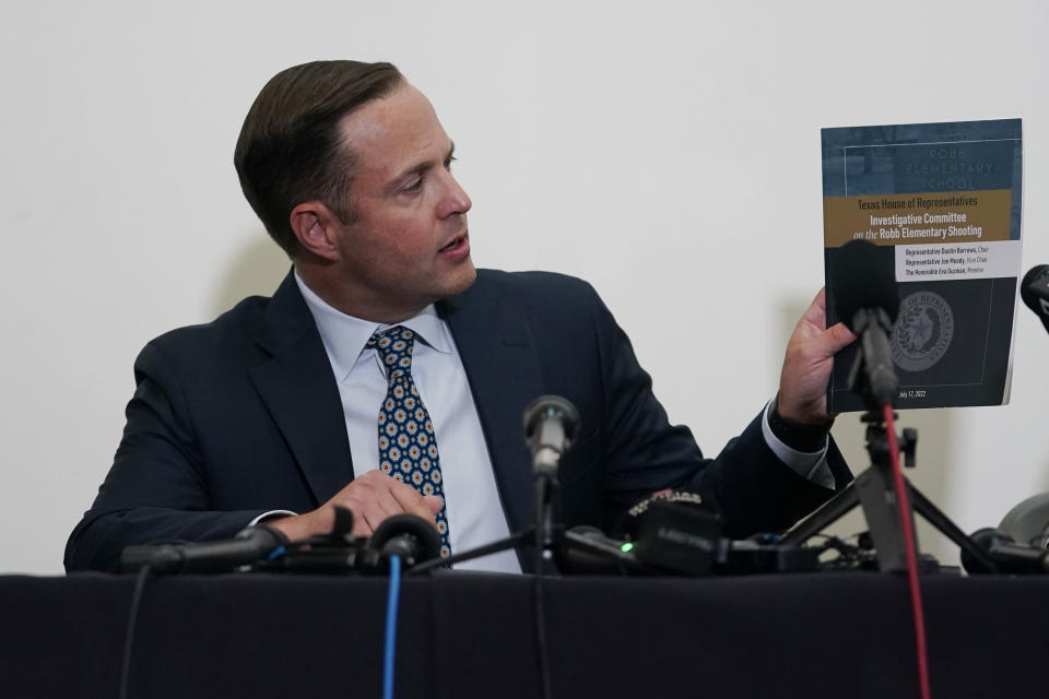 Texas House investigative committee chairman Rep. Dustin Burrows holds a copy of its full report on the shootings at Robb Elementary School as the committee meets, Sunday, July 17, 2022, in Uvalde, Texas. (AP Photo/Eric Gay)