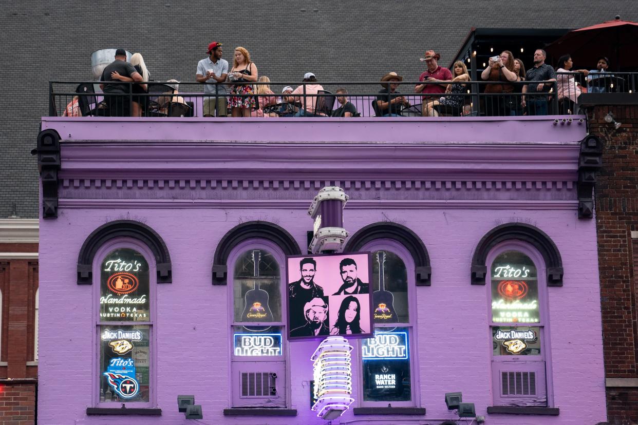 Patrons drink on the rood of Tootsies on Lower Broadway in Nashville, Tenn., Friday, July 14, 2023.