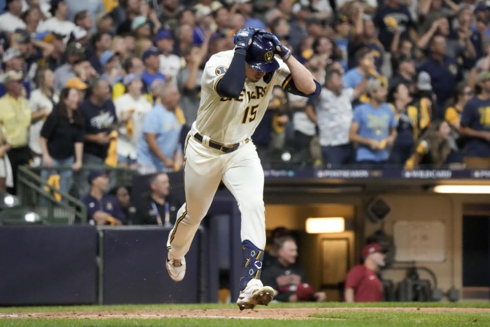 Milwaukee Brewers' Tyrone Taylor reacts after hitting into a double play with bases loaded during the fifth inning of a Game 1 of their National League wildcard baseball series against the Arizona Diamondbacks Tuesday, Oct. 3, 2023, in Milwaukee. (AP Photo/Morry Gash)