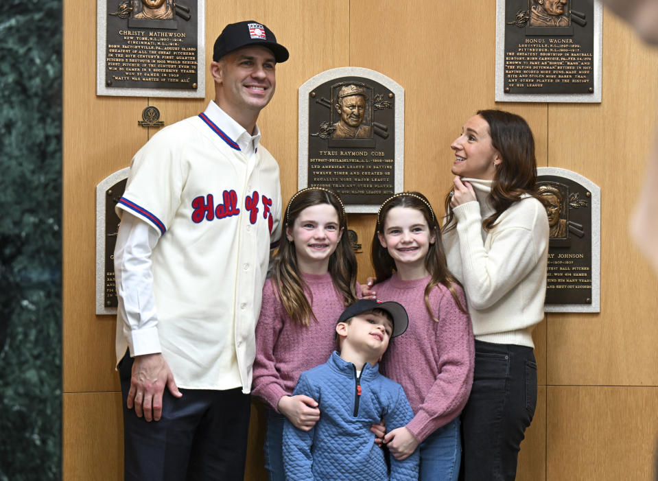 Newly elected Baseball Hall of Fame inductee Joe Mauer poses for a photograph with his family in the plaque room after a news conference Thursday, Jan. 25, 2024, in Cooperstown, N.Y. (AP Photo/Hans Pennink)