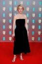 <p>Gillian Anderson teamed her strapless velvet dress with red heels and a matching clutch bag. </p>