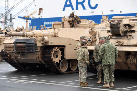 FILE PHOTO: U.S. tanks, trucks and other military equipment, which arrived by ship, are unloaded in the harbour of Bremerhaven, Germany January 8, 2017. REUTERS/Fabian Bimmer/File Photo