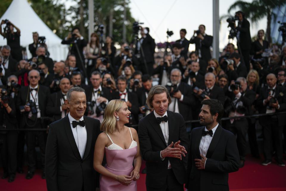 Tom Hanks, from left, Scarlett Johansson, director Wes Anderson and Jason Schwartzman pose for photographers upon arrival at the premiere of the film 'Asteroid City' at the 76th international film festival, Cannes, southern France, Tuesday, May 23, 2023. (AP Photo/Daniel Cole)