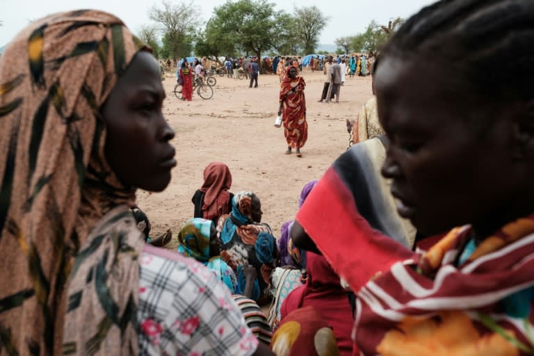 Un grupo de personas recién llegadas a un campo de desplazados internos aguarda a recibir tarjetas para el reparto de alimentos, el 17 de junio de 2024 en Agari (Sudán) (Guy Peterseon)