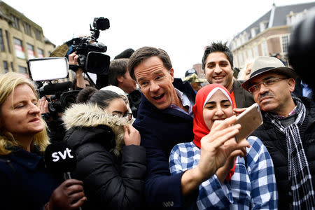 Dutch Prime Minister Mark Rutte of the VVD Liberal party greets supporters during campaigning in The Hague, Netherlands March 14, 2017. REUTERS/Dylan Martinez