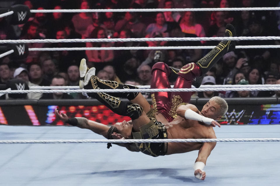 FILE - Wrestler Carmelo Hayes, top, tangles with Akira Tozawa during the WWE Monday Night RAW event, March 6, 2023, in Boston. This year's WrestleMania may be just days away, but the marketing run up to WWE's biggest premium live event went into overdrive months ago. (AP Photo/Charles Krupa, File)