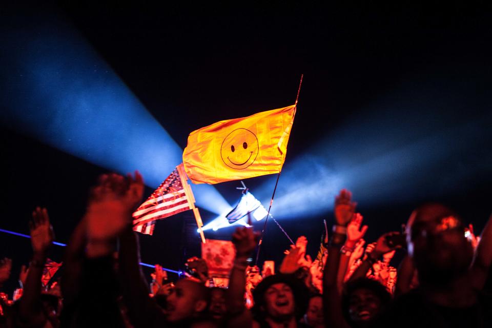 Fans cheer and wave flags as Outkast performs at Counterpoint 2014 Sunday, April 27, 2014, in Rome, Ga. (AP Photo/Branden Camp)