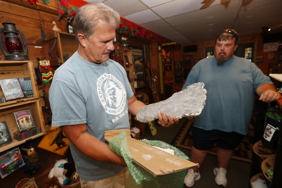 This Aug. 8, 2019, photo shows Bigfoot researcher David Bakara opening a box containing plaster cast of footprints said to be from a Russian Bigfoot at Expedition: Bigfoot! The Sasquatch Museum in Cherry Log, Ga. Bakara, a longtime member of the Bigfoot Field Researchers Organization who served in the Navy, drove long-haul trucks and tended bar before opening the museum in early 2016 with his wife, Malinda. (AP Photo/John Bazemore)