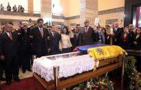 FILE PHOTO: Acting Venezuelan President Maduro swears an oath in front of the coffin of late Venezuelan President Chavez during the funeral at the military academy in Caracas in this picture provided by Miraflores Palace