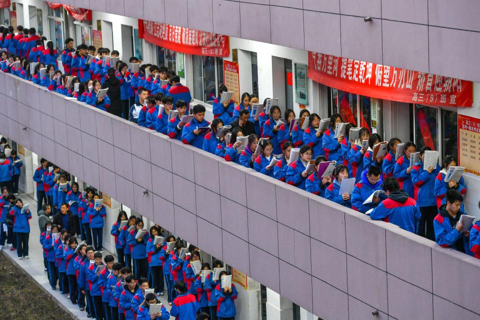 Senior three students study in the corridor outside a classroom to prepare for gaokao, China's national college entrance examination, on February 27, 2023 in Huzhou, Zhejiang Province of China.