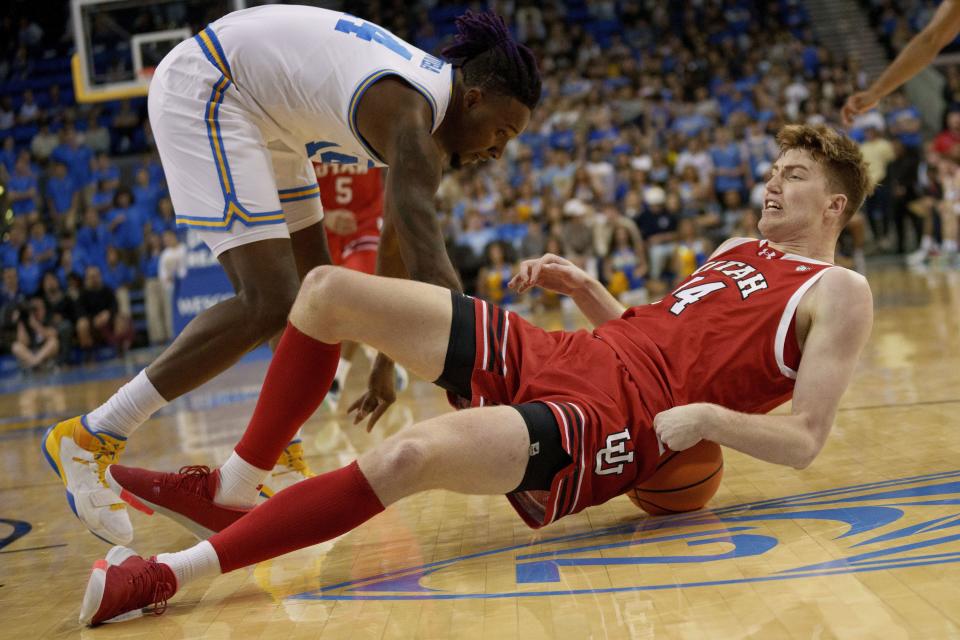 Utah guard Brandon Haddock (14) lands on the ball during the first half of an NCAA college basketball game against UCLA, Sunday, Feb. 18, 2024, in Los Angeles. | Eric Thayer, AP