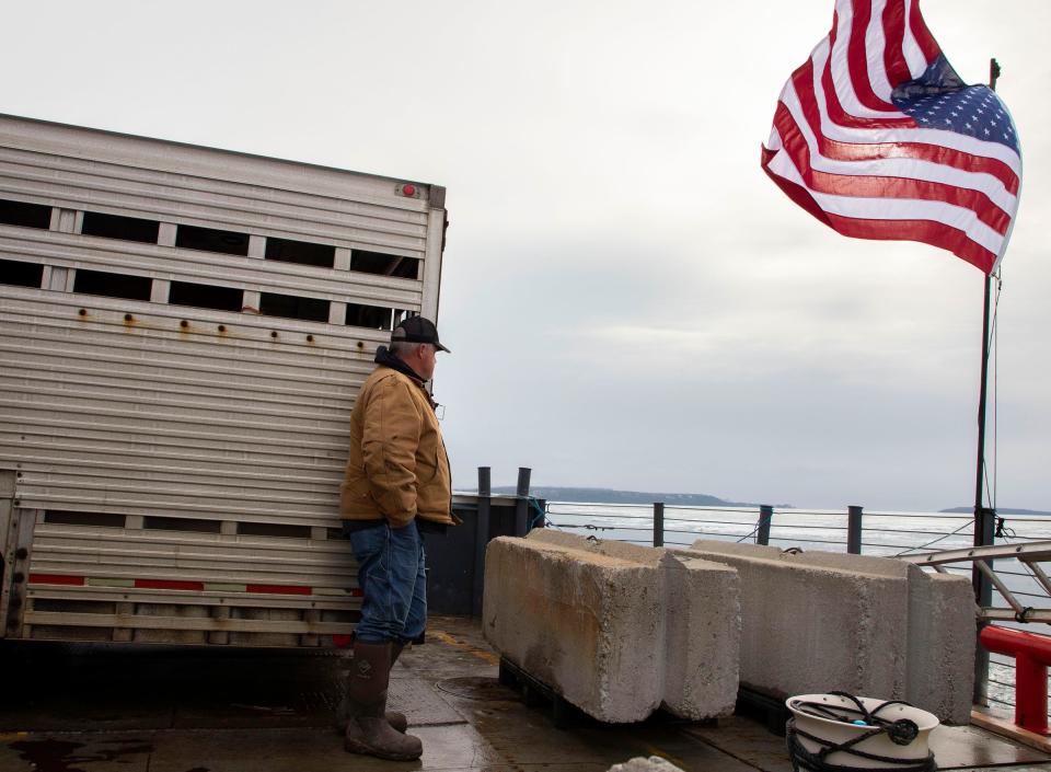 Ron Atkins leans on a horse trailer after backing it on a ferry at the Arnold Freight Co. freight terminal as they prepare transport the animals to Mackinac Island from St. Ignace on Monday, April 4, 2022.