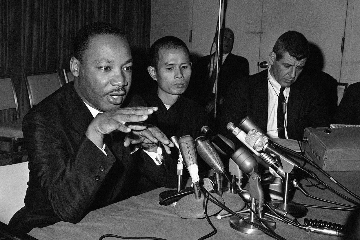 FILE - Dr. Martin Luther King Jr., left, appearing in a Chicago news conference with Thich Nhat Hanh, a Buddhist monk from Viet Nam, suggests a halt in bombing of Viet Nam, May 31, 1966. Thich Nhat Hanh, the revered Zen Buddhist monk who helped pioneer the concept of mindfulness in the West and socially engaged Buddhism in the East, has died. He was 95. (AP Photo/Edward Kitch, File) ORG XMIT: BKWS313