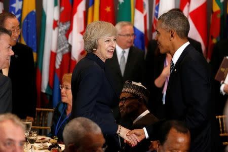 U.S. President Barack Obama (R) greets British Prime Minister Theresa May as he arrives for a luncheon during the United Nations General Assembly at United Nations headquarters in New York City, U.S. September 20, 2016. REUTERS/Lucas Jackson