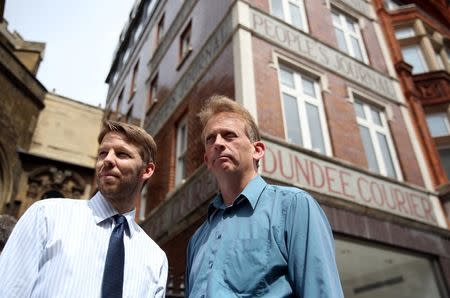 Journalists Darryl Smith (L) and Gavin Sherriff pose for a photograph outside The Sunday Post building in Fleet Street in London, Britain August 5, 2016. REUTERS/Neil Hall