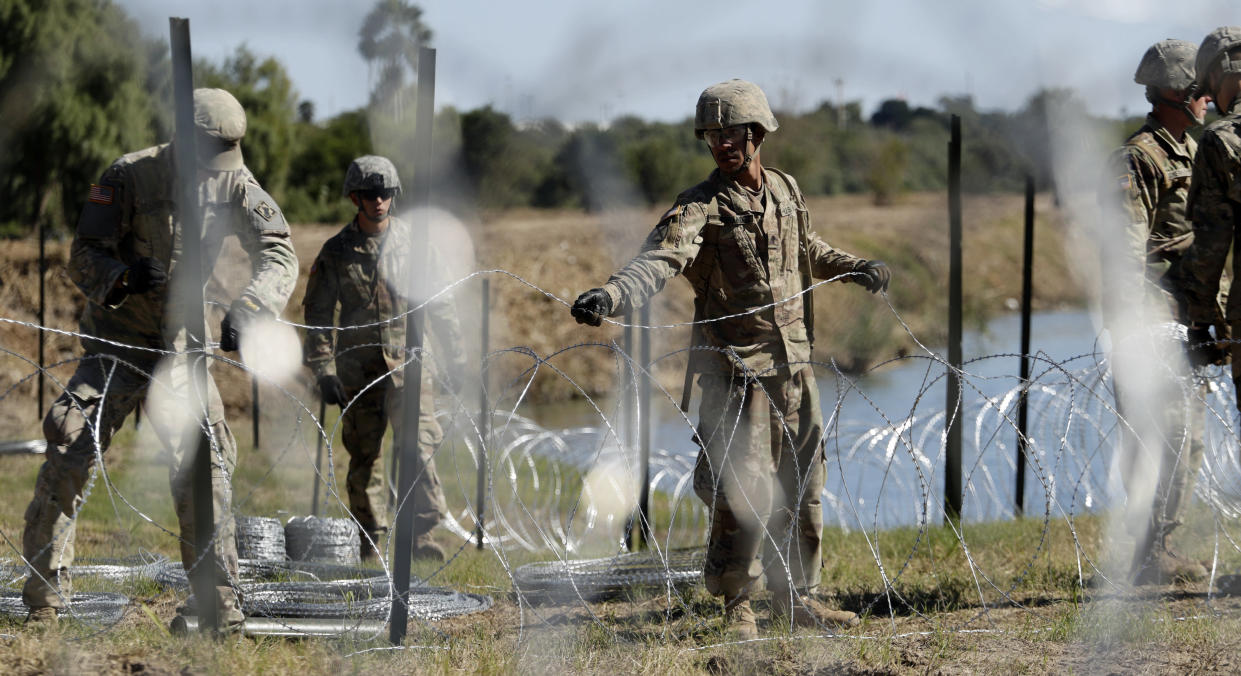 Members of the U.S. military install concertina wire along the banks of the Rio Grande at the U.S.-Mexico border in Laredo, Texas, on Nov. 16, 2018. (Eric Gay/AP)