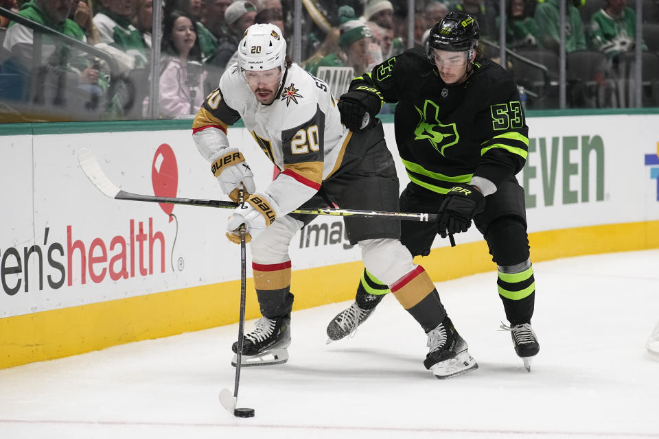 Vegas Golden Knights center Chandler Stephenson (20) skates with the puck against Dallas Stars center Wyatt Johnston (53) during the second period of an NHL hockey game, Wednesday, Nov. 22, 2023, in Dallas. (AP Photo/Tony Gutierrez)