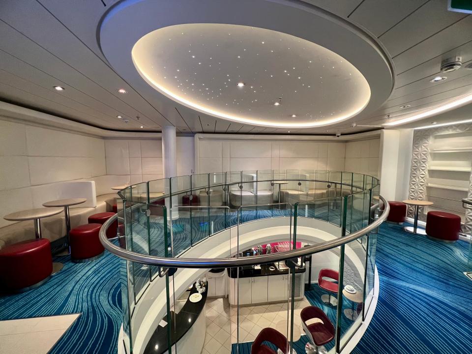 Norwegian Getaway studio lounge top floor with seating in a circular space and lights on ceiling