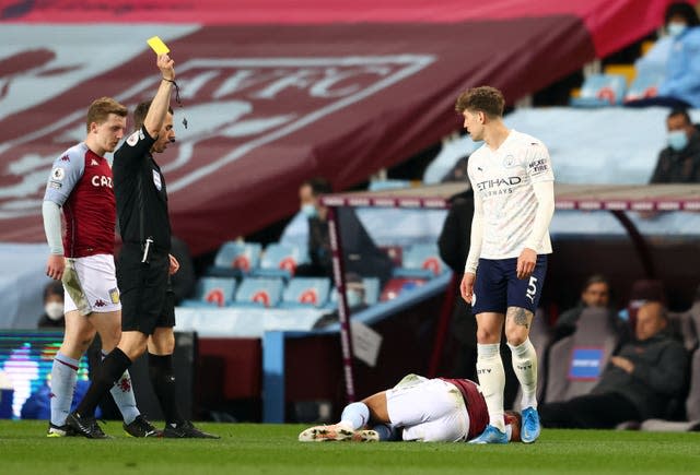 John Stones (right) is booked