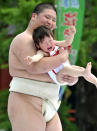 A crying baby is carried by a student sumo wrestler during the "Baby-cry Sumo" competition at Tokyo's Sensoji temple on April 30, 2011. Some 50 babies aged under one participated in the annual baby crying contest. Japanese parents believe that sumo wrestlers can help make babies cry out a wish to grow up with good health. AFP PHOTO/Yoshikazu TSUNO