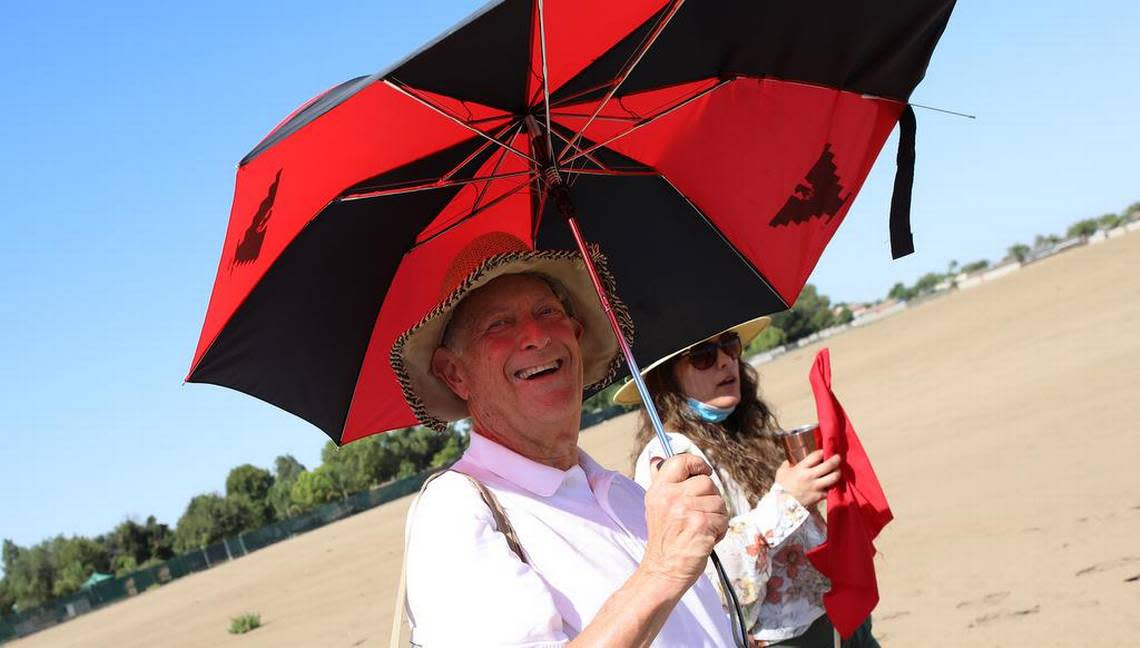 United Farm Workers vice-president Irv Hershenbaum uses an umbrella as protection from the sun.