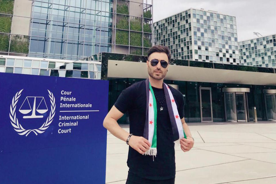 This photo provided by Syrian opposition activist Nedal al-Amari shows him standing outside the International Criminal Court in The Hague, Netherlands, on June 7, 2019. Al-Amari was among the first to join the protests against the Assad family rule amid Arab Spring uprisings in 2011 in his hometown of Daraa, Syria. (Nedal al-Amari via AP)