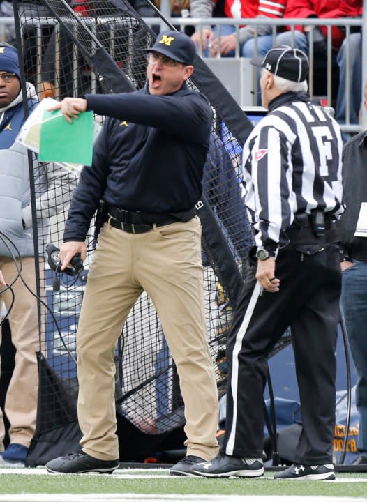FILE – Michigan head coach Jim Harbaugh, left, yells at the field judge during the first half of an NCAA college football game against Ohio State, Saturday, Nov. 26, 2016, in Columbus, Ohio. Harbaugh said he was “bitterly disappointed with the officiating” after the 30-27 loss.(AP Photo/Jay LaPrete)