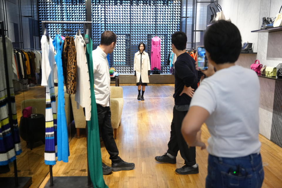 Jack McCollough and Lazaro Hernandez showcasing a look to host Zoe Zhang during the Proenza Schouler Tmall livestream. - Credit: Courtesy of Alibaba