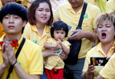 People react as they watch the coronation procession for Thailand's newly crowned King Maha Vajiralongkorn in Bangkok, Thailand May 5, 2019. REUTERS/Soe Zeya Tun
