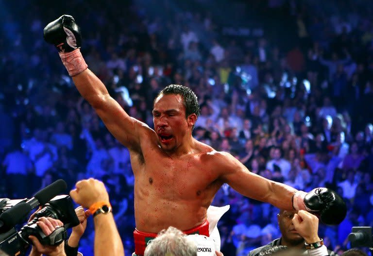 A bloodied Juan Manuel Marquez celebrates after defeating Manny Pacquiao by a sixth round knockout in their welterweight bout at the MGM Grand Garden Arena in Las Vegas. The shocking ending stunned the crowd of 16,348 because Marquez had held his own in their first three fights but had never even knocked down Pacquiao until Saturday night