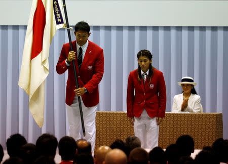 Japanese decathlete and flag bearer Keisuke Ushiro (L) bows with women's wrestler and team captain Saori Yoshida (C) as Crown Princess Masako looks on, during a team-forming ceremony ahead of the Japanese team's departure to the Rio 2016 Olympic Games, in Tokyo, Japan July 3, 2016. REUTERS/Issei Kato