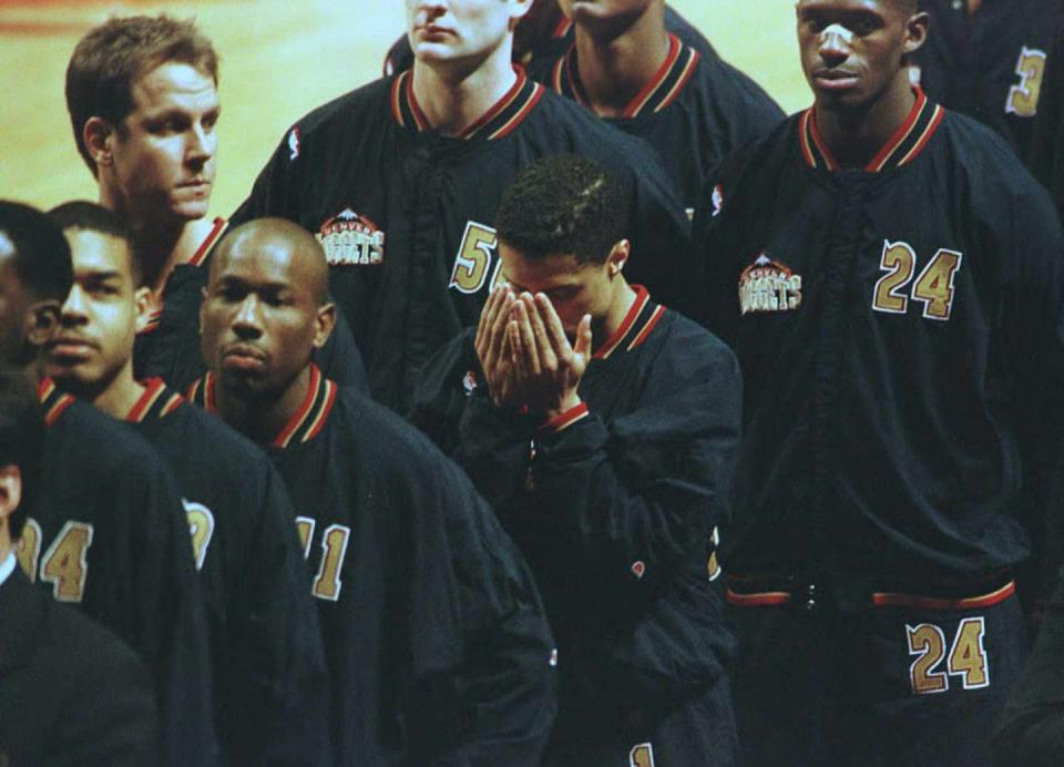 <span class="caption">Mahmoud Abdul-Rauf bows his head in prayer during the singing of the national anthem.</span> <span class="attribution"><a class="link " href="https://www.gettyimages.com/detail/news-photo/denver-nuggets-guard-mahmoud-abdul-rauf-bows-his-head-in-news-photo/51975529?adppopup=true" rel="nofollow noopener" target="_blank" data-ylk="slk:Eric Chu/AFP via Getty Images;elm:context_link;itc:0;sec:content-canvas">Eric Chu/AFP via Getty Images</a></span>